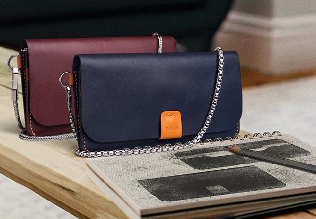 Carry on leather wallet with shoulder strap in navy and burgundy in Pakistan.