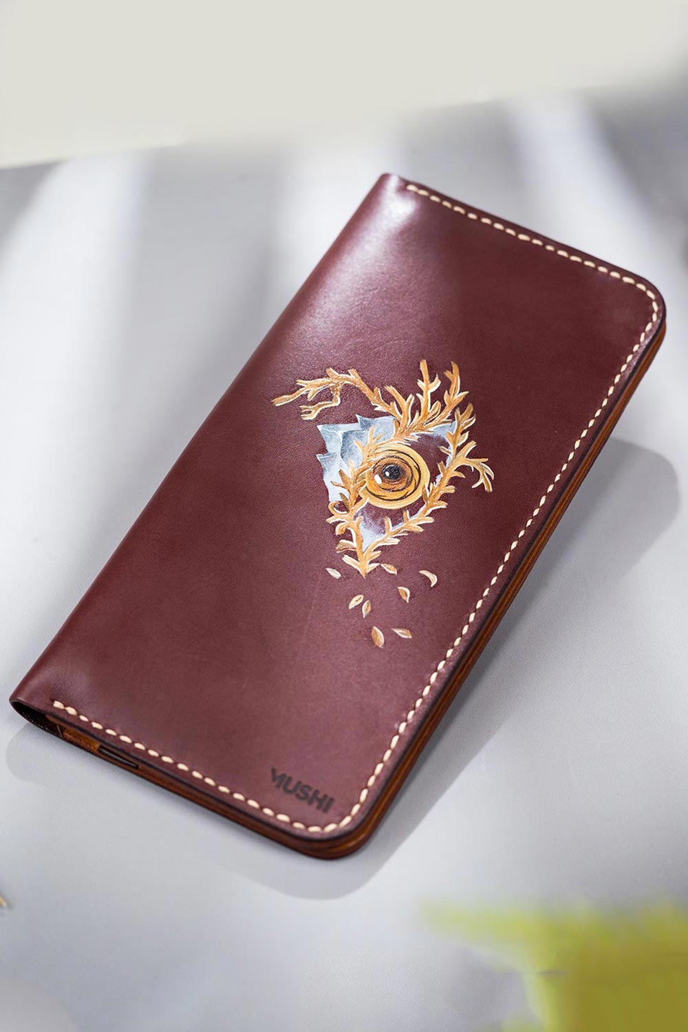 Imported genuine long leather wallet in burgundy with eye and the mountain painting in Pakistan.