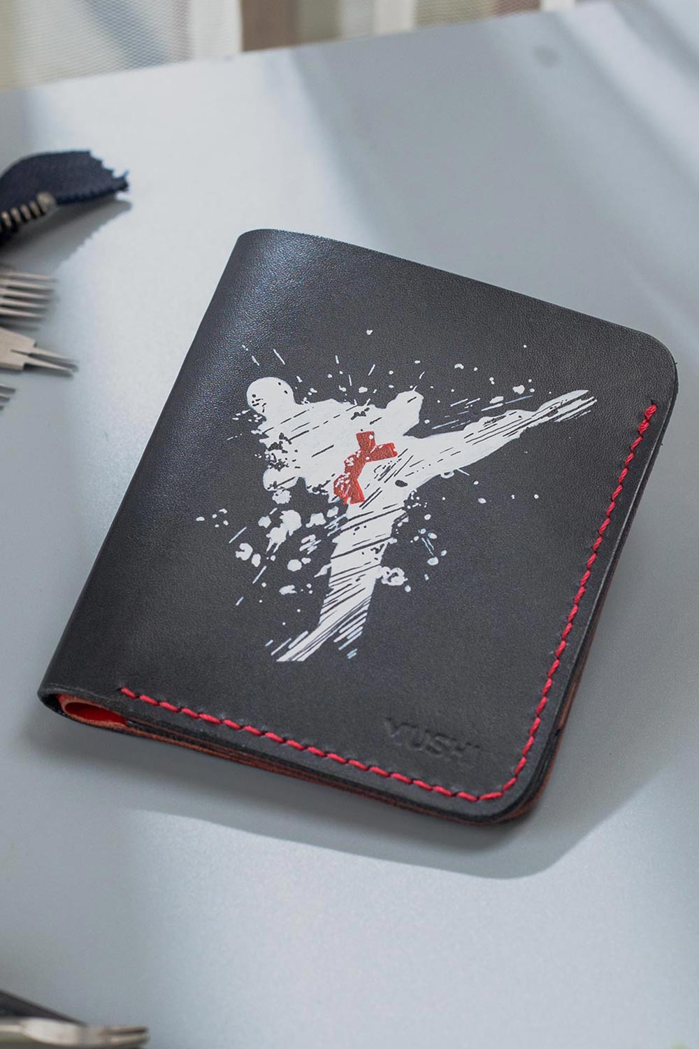 Imported genuine minimalist leather wallet in black with taekwondo player painting in Pakistan.