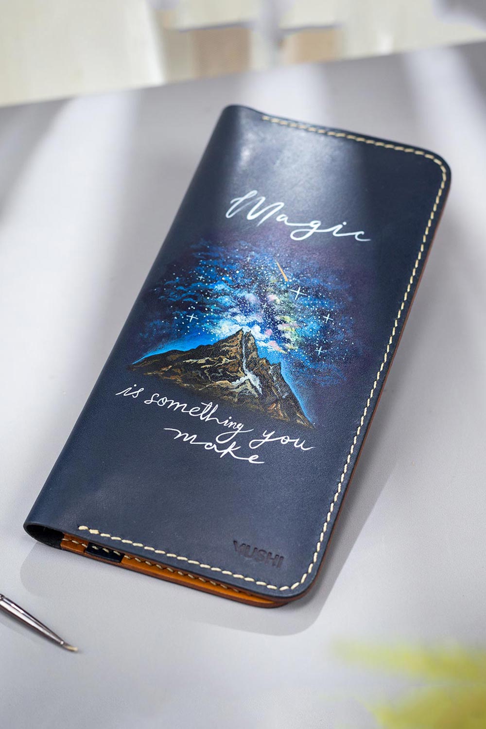 Imported genuine long leather wallet in navy with mountain landscape painting in Pakistan.