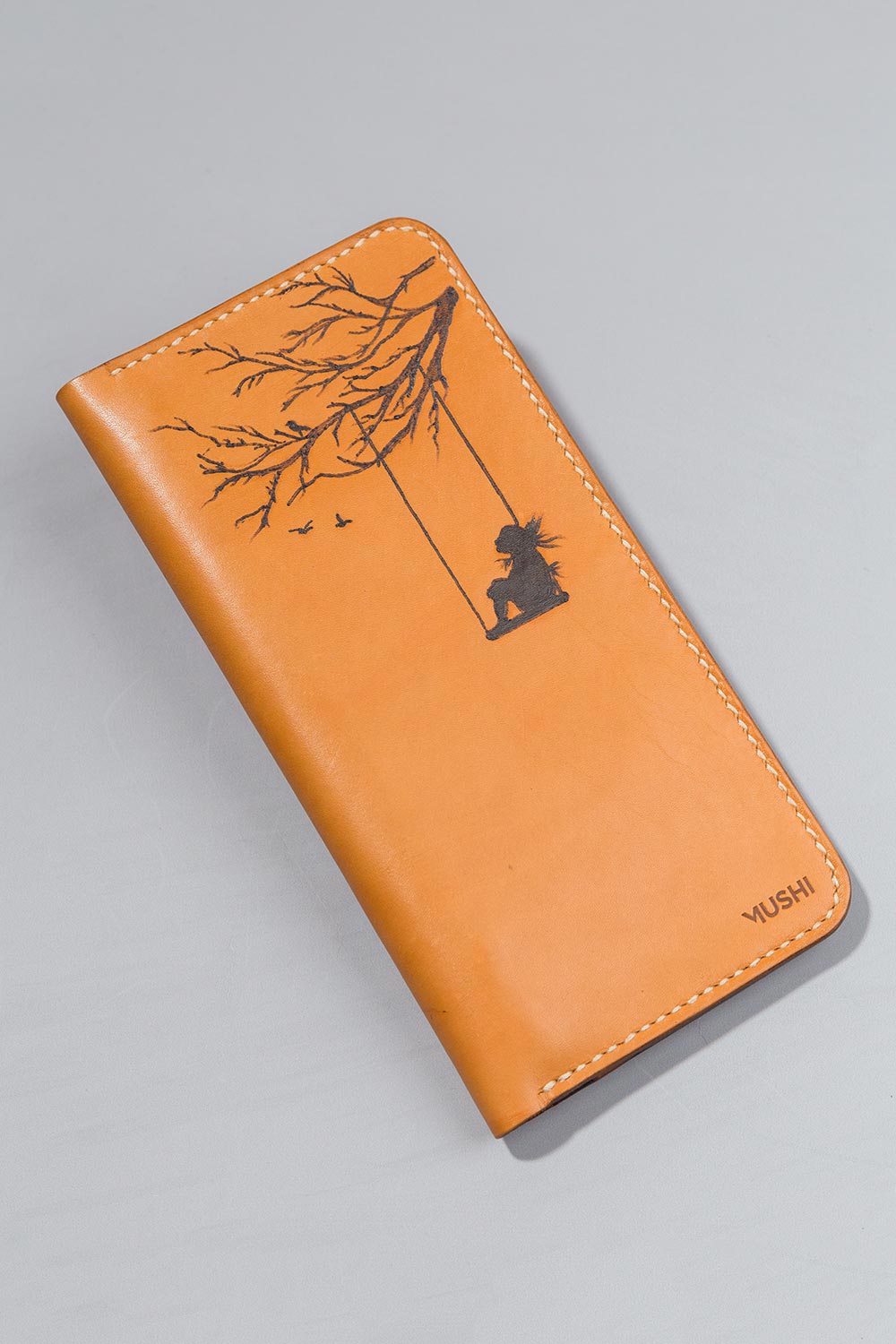 Imported genuine long leather wallet in beige with girl on a swing painting in Pakistan.