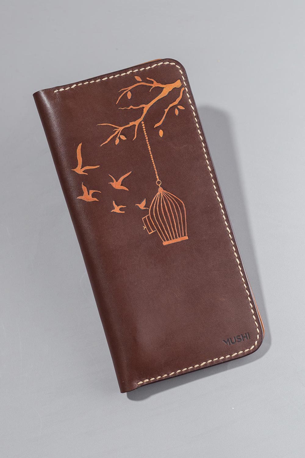 Imported genuine long leather wallet in burgundy with birds flying out of a cage painting in Pakistan.