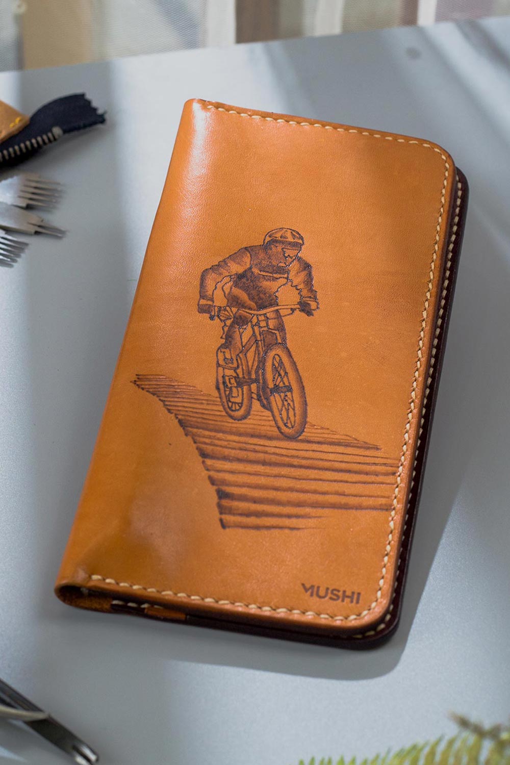 Imported genuine long leather wallet in beige with bicycle rider painting in Pakistan.
