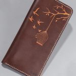 Imported genuine long leather wallet in burgundy with birds flying out of a cage painting in Pakistan.