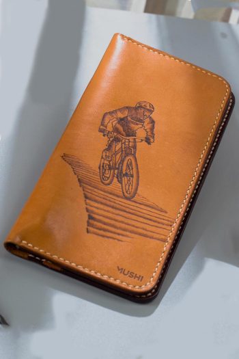 Imported genuine long leather wallet in beige with bicycle rider painting in Pakistan.
