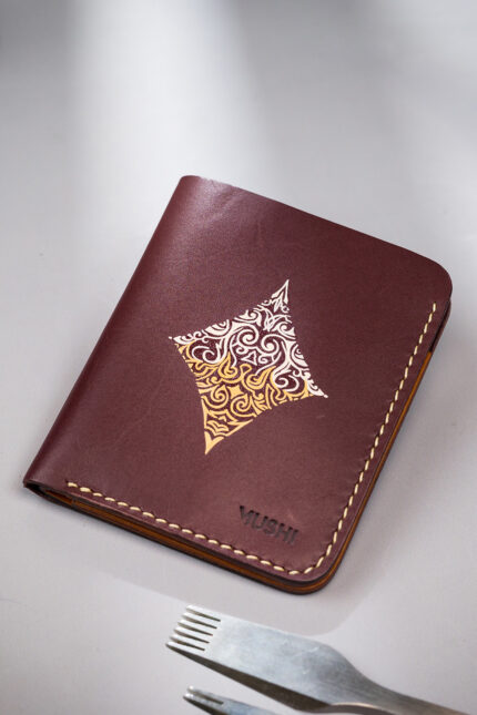 Burgundy vegetable-tanned leather with a diamond abstract design.