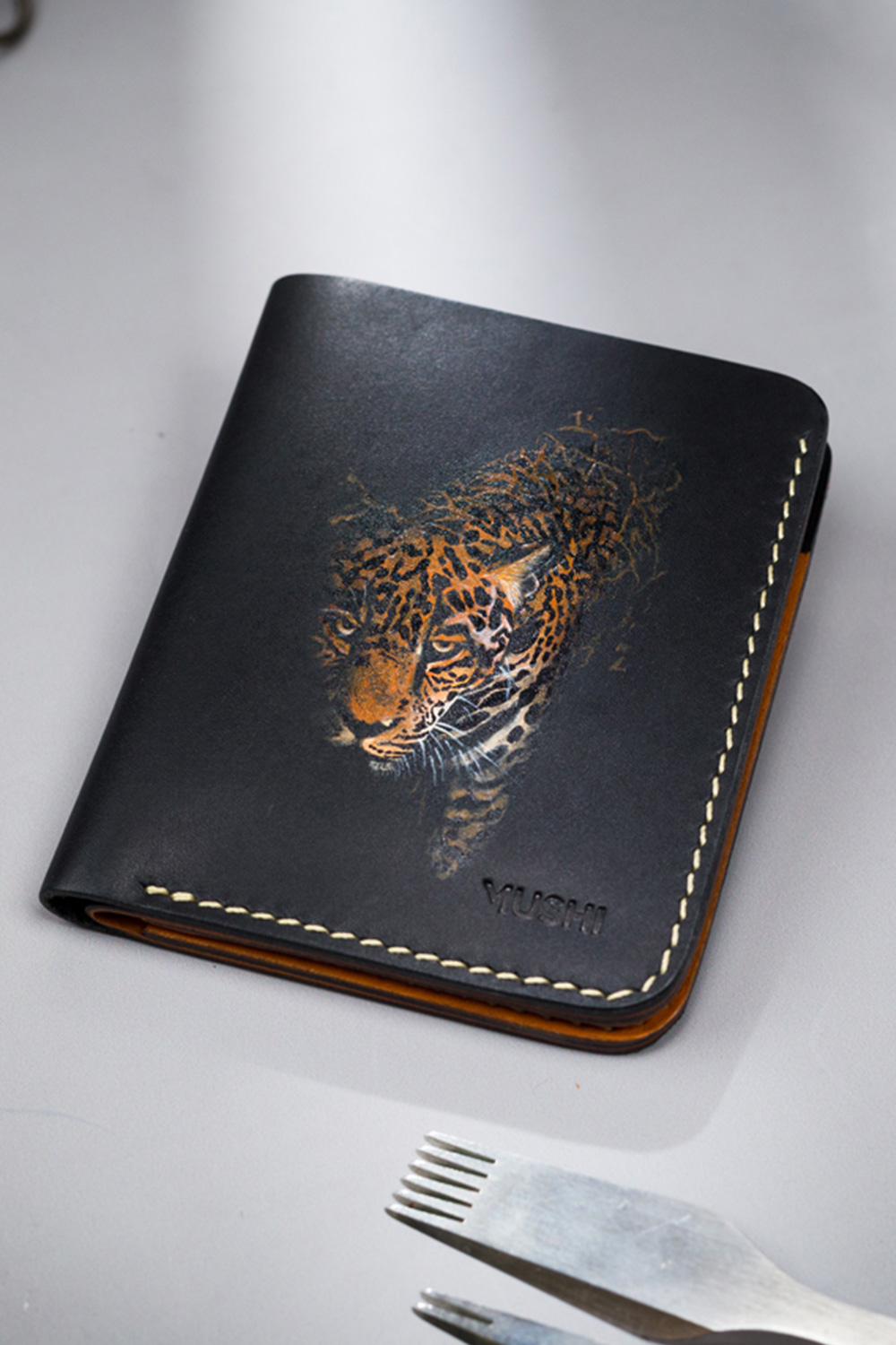 Fierce-Look-Featured-Image Genuine minimalist leather wallet with pull-out strap in black with fierce leopard painting in Pakistan.