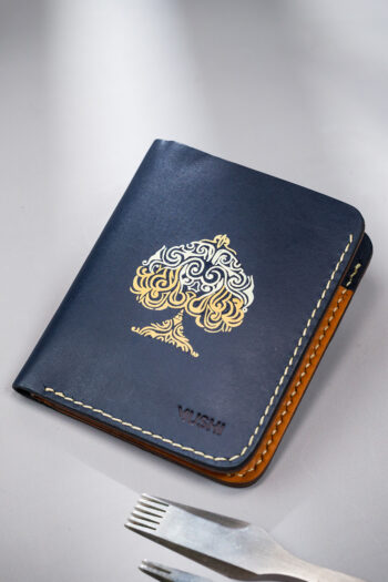 Navy vegetable-tanned leather with a spade abstract design.