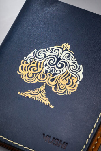 Navy vegetable-tanned leather with a spade abstract design.
