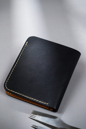 Genuine minimalist leather wallet with pull-out strap in black with eagle painting in Pakistan.