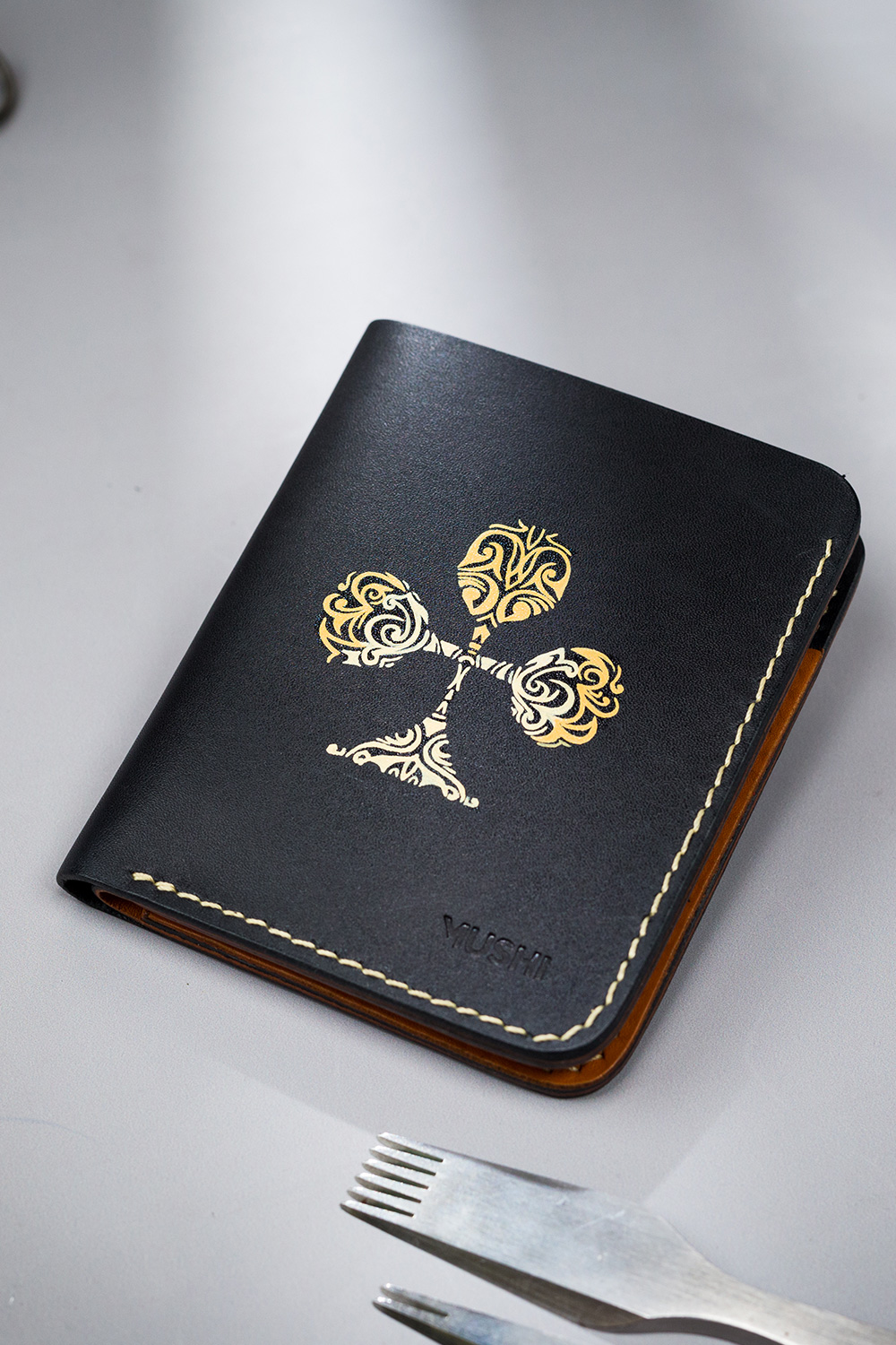 CLUB-ABSTRACT-FOOTER-IMAGE-TWO Black vegetable-tanned leather with a club abstract design.