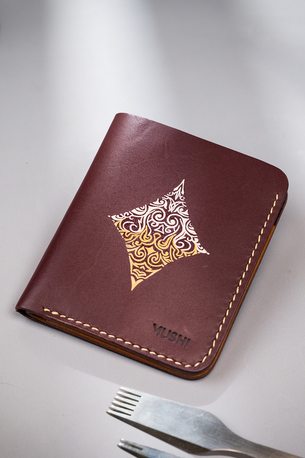 Burgundy vegetable-tanned leather with a diamond abstract design.
