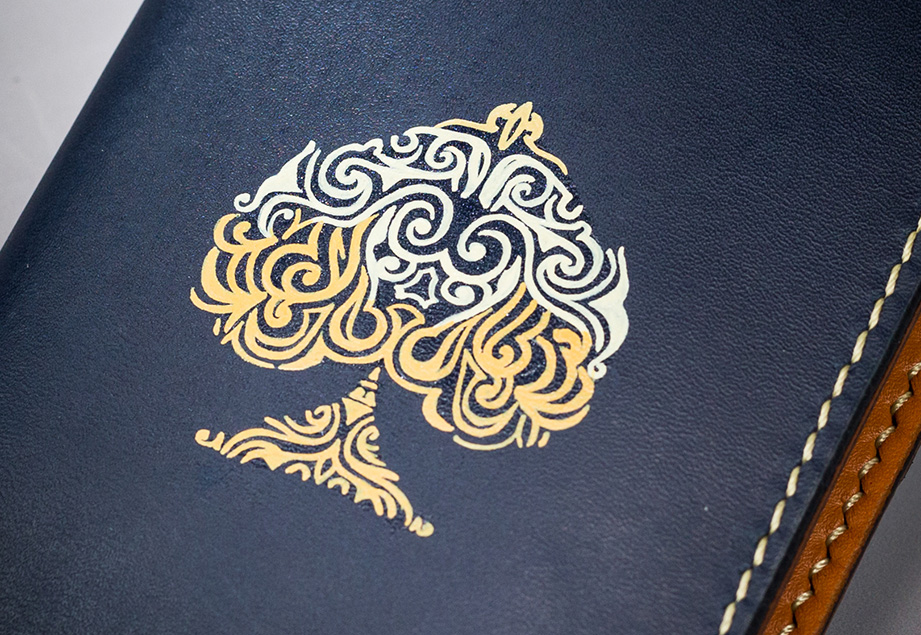 Navy vegetable-tanned leather with a spade abstract design.