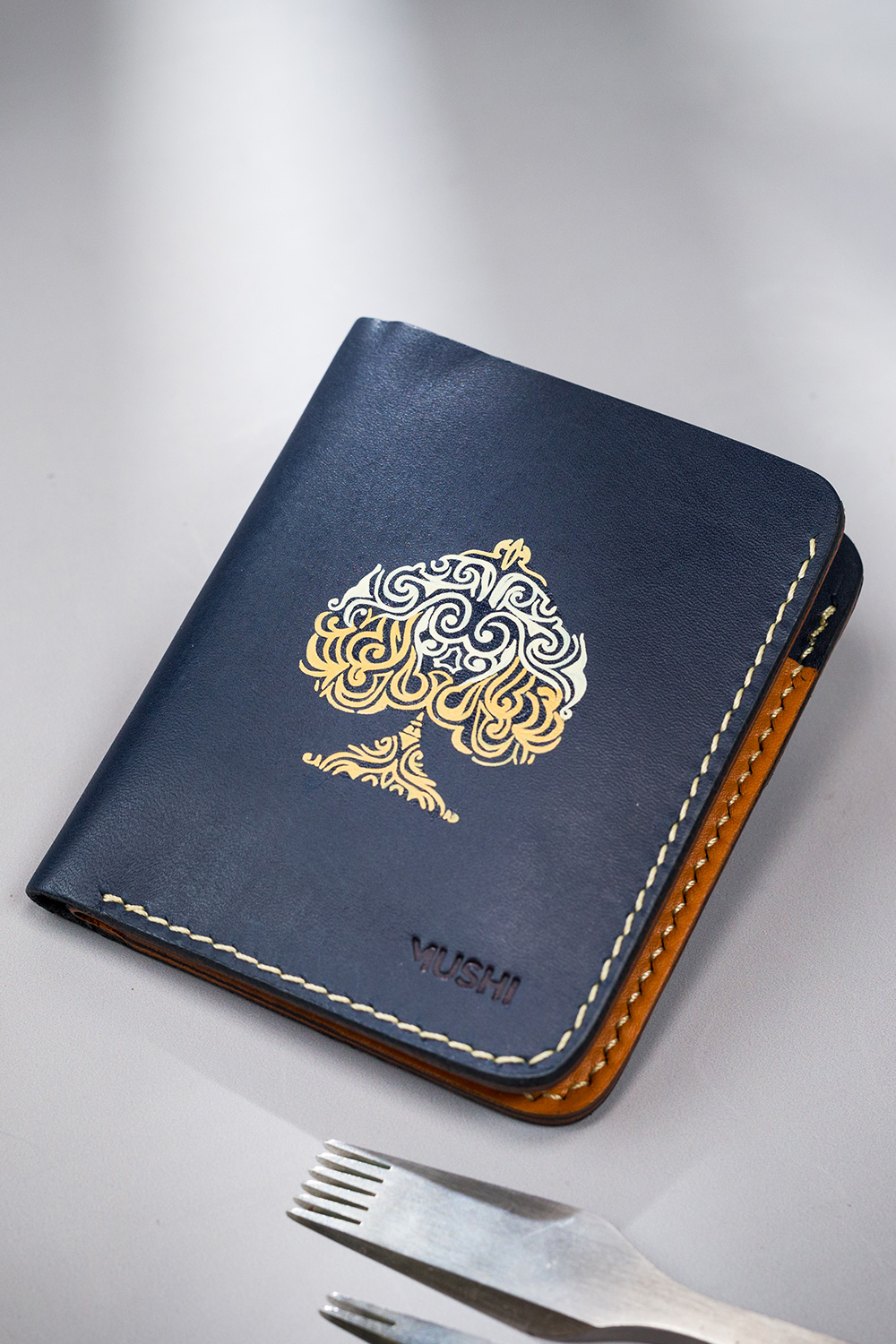 Navy vegetable-tanned leather with a spade abstract design.