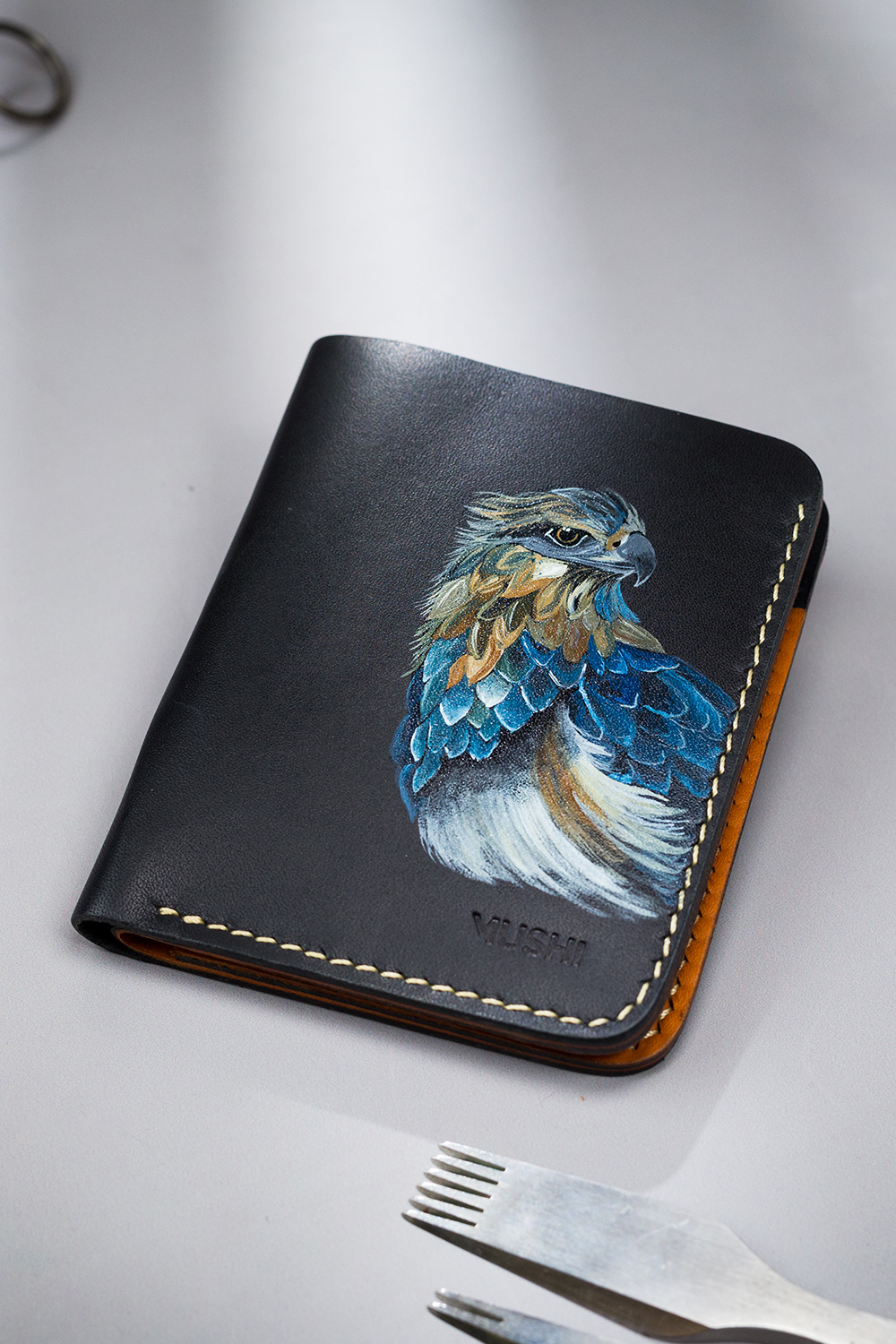 Genuine minimalist leather wallet with pull-out strap in black with eagle painting in Pakistan.