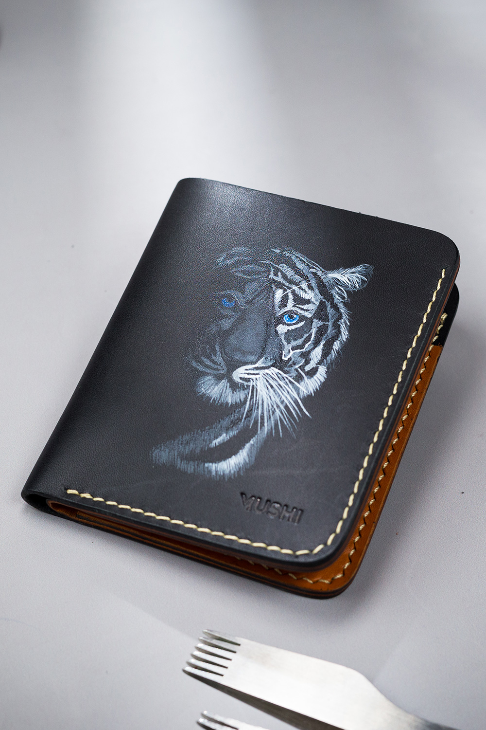 Genuine minimalist leather wallet with pull-out strap in black with white tiger painting in Pakistan.