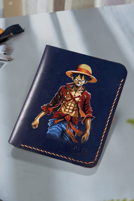 Hand-painted Monkey D. Luffy artwork on handcrafted leather wallet by MUSHI for anime fans.