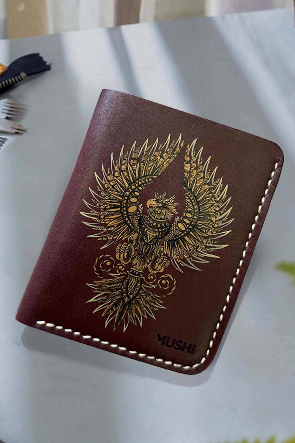Hand-painted leather wallet featuring gold phoenix design, luxury handmade artisan wallet